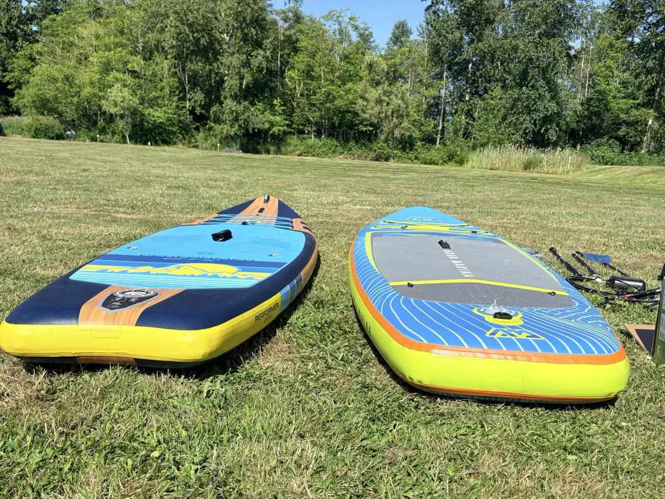 Low angle side view comparing the thickness and rail shape of the Aqua Marina Revolution and Body Glove Performer GTS